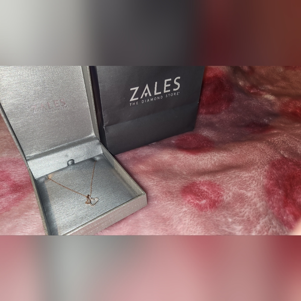 1/20 CT. T.W. Diamond Tilted Double Heart Pendant in 10K Rose Gold